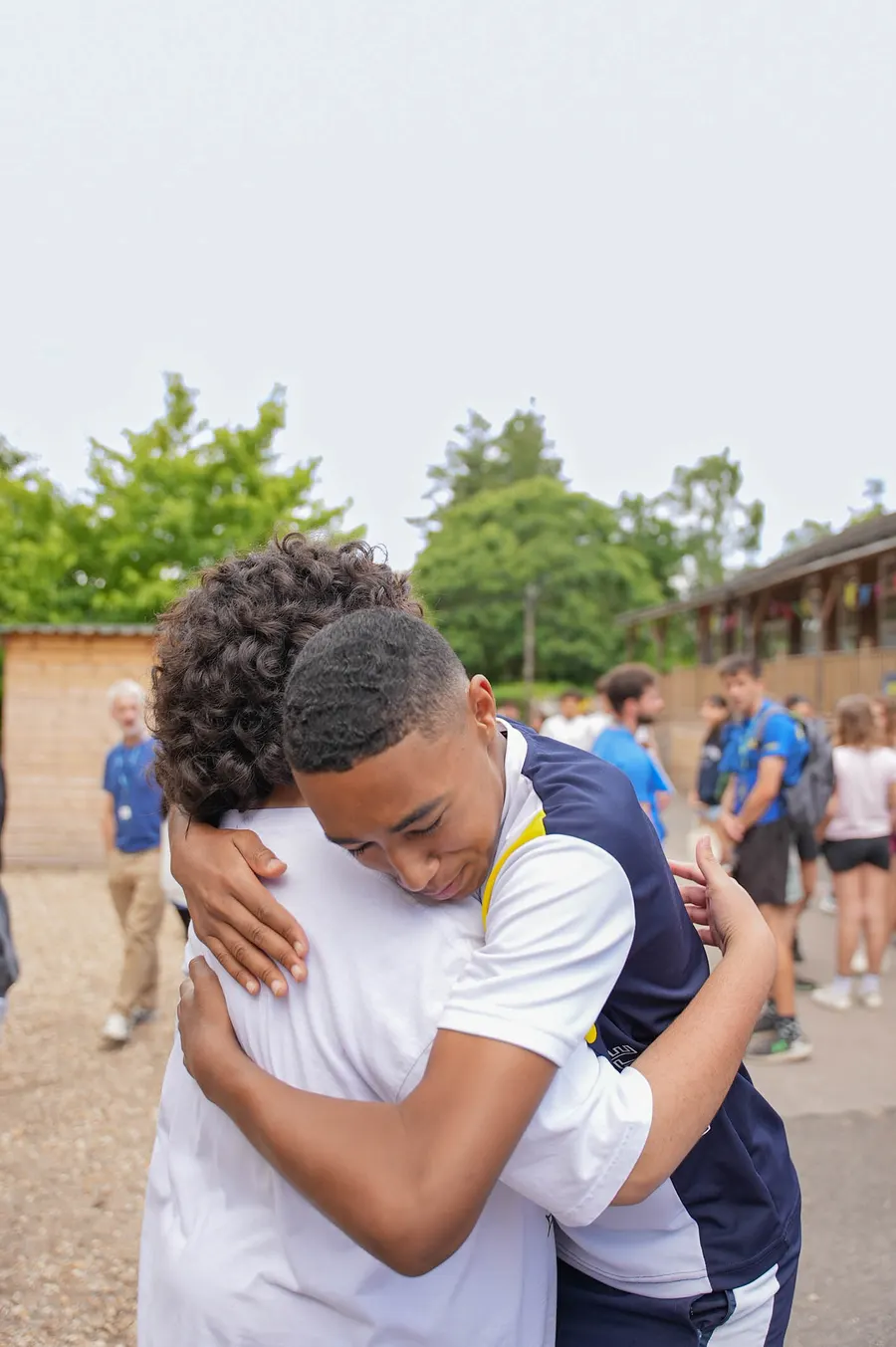 Two students hugging at camp