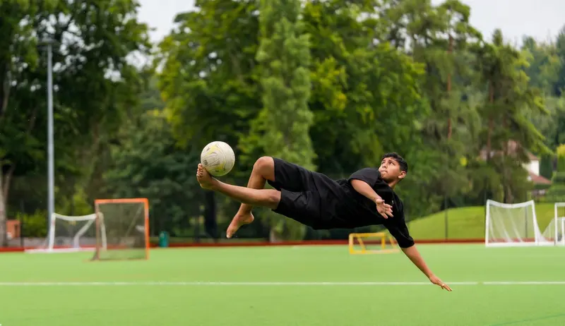 Boy doing bicycle kick on football field